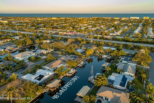 a kitchen with white cabinets and window