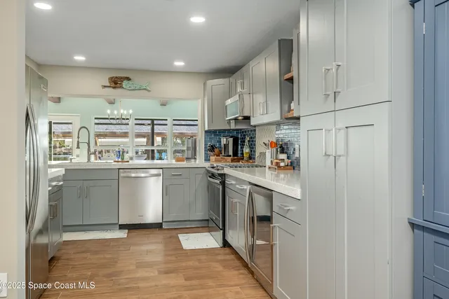 a kitchen with stainless steel appliances granite countertop a refrigerator and a stove