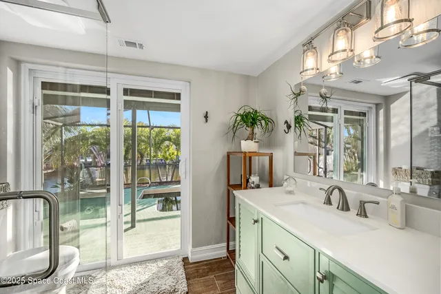 a bed room with a bed television and a window