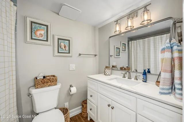 an empty room with fan ceiling fan and windows