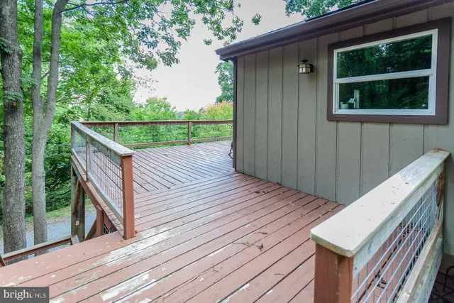 a view of deck with wooden floor and fence with a garden view