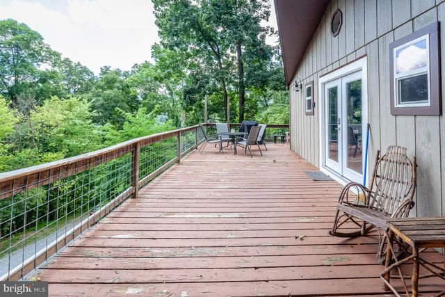 a view of balcony with wooden floor and outdoor seating
