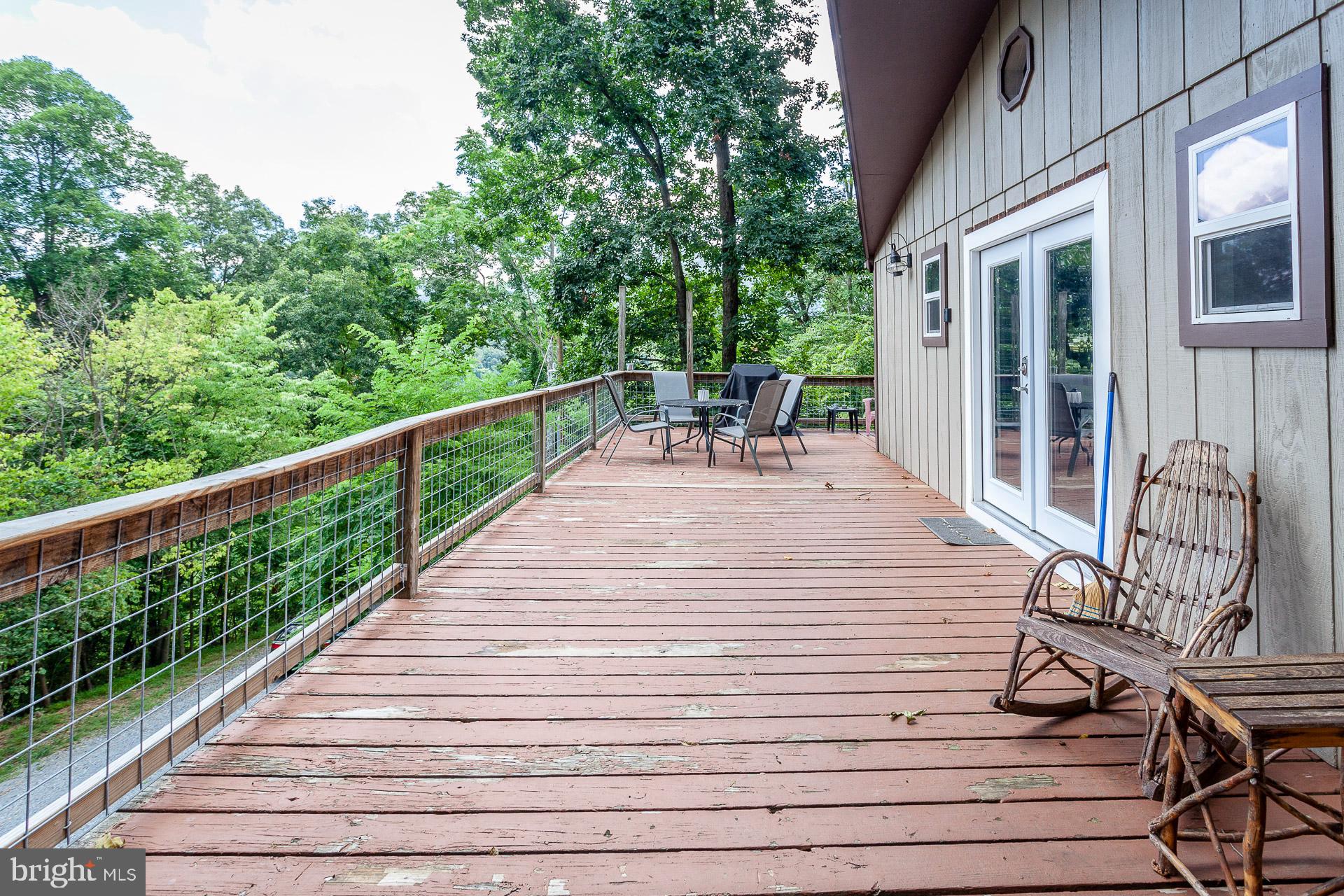 2668 Pine Grove Road Stanley, VA 22851 - Photo 12 of 35 a view of balcony with wooden floor and outdoor seating