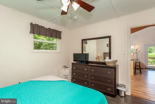 a room with a bed and a television