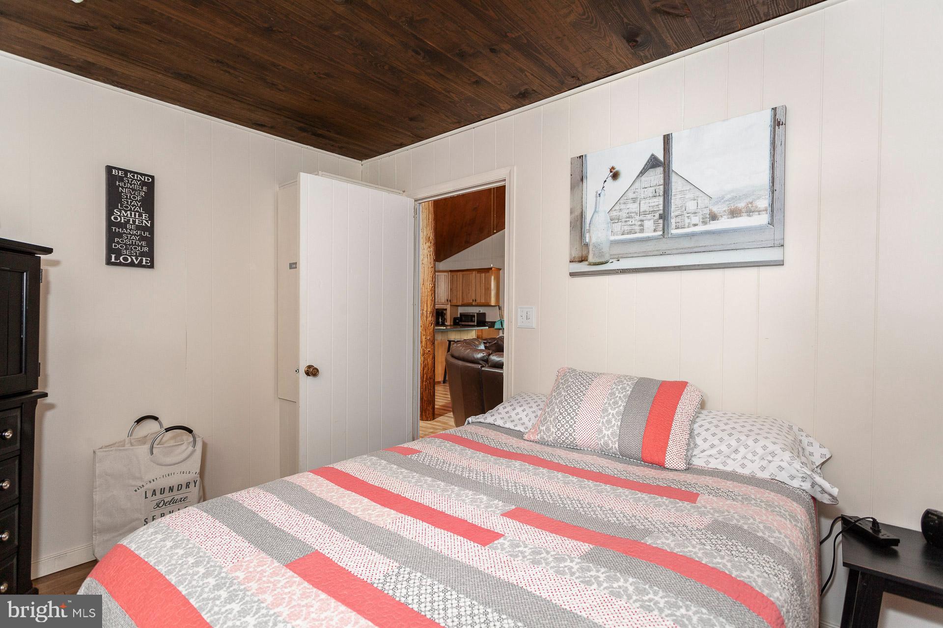 2668 Pine Grove Road Stanley, VA 22851 - Photo 32 of 35 a bedroom with bed and wall painting