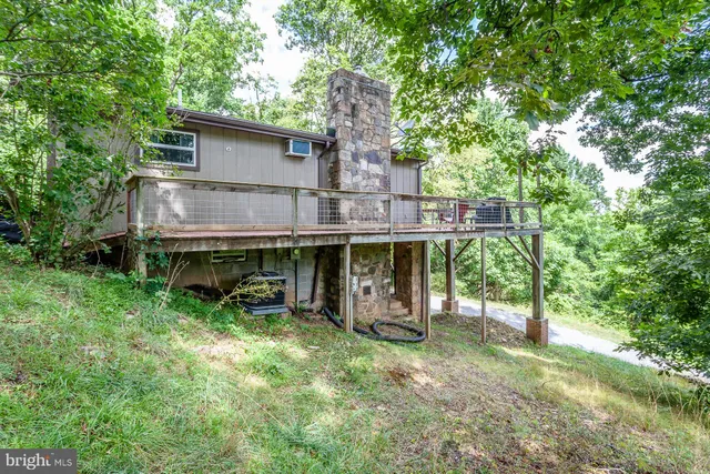 a view of a house with backyard porch and sitting area