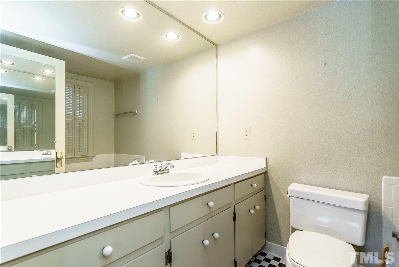 2515 White Oak Road Raleigh, NC 27609 - Photo 22 of 25 a bathroom with a toilet sink and mirror