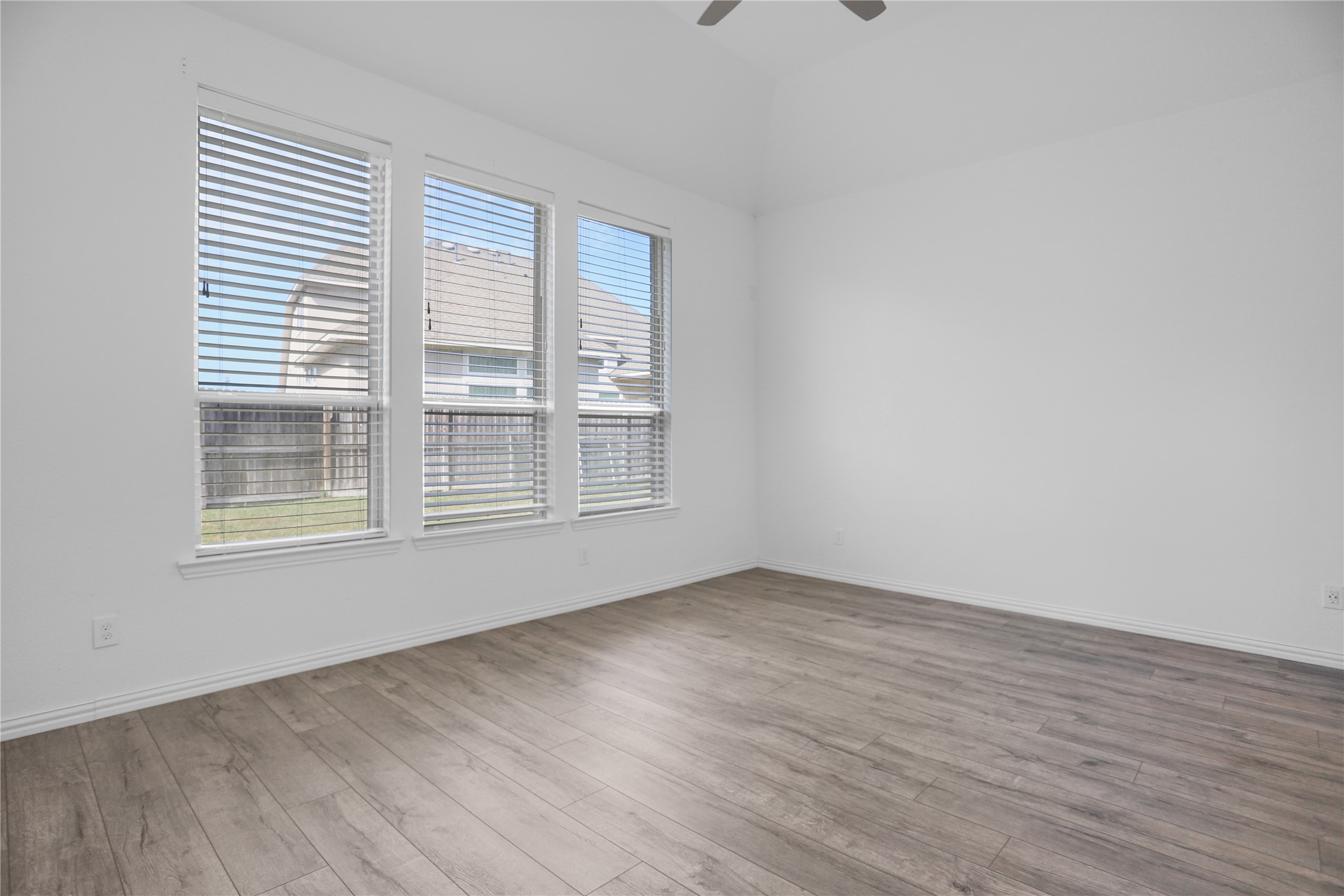 2718 Ripe Amber Cup Court Richmond, TX 77406 - Photo 11 of 43 a view of an empty room with wooden floor and a window