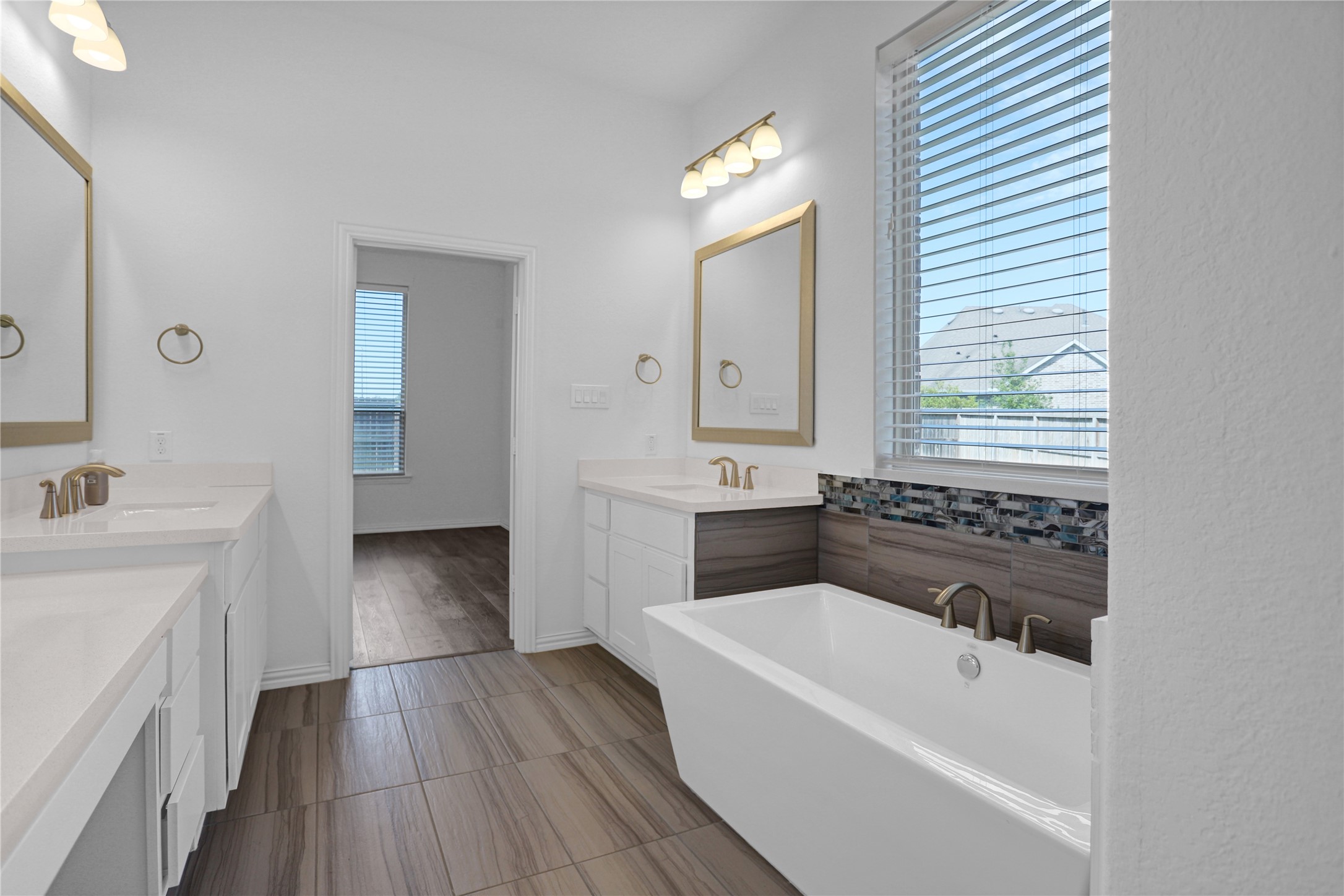 2718 Ripe Amber Cup Court Richmond, TX 77406 - Photo 15 of 43 a bathroom with a bathtub a sink and wooden floor