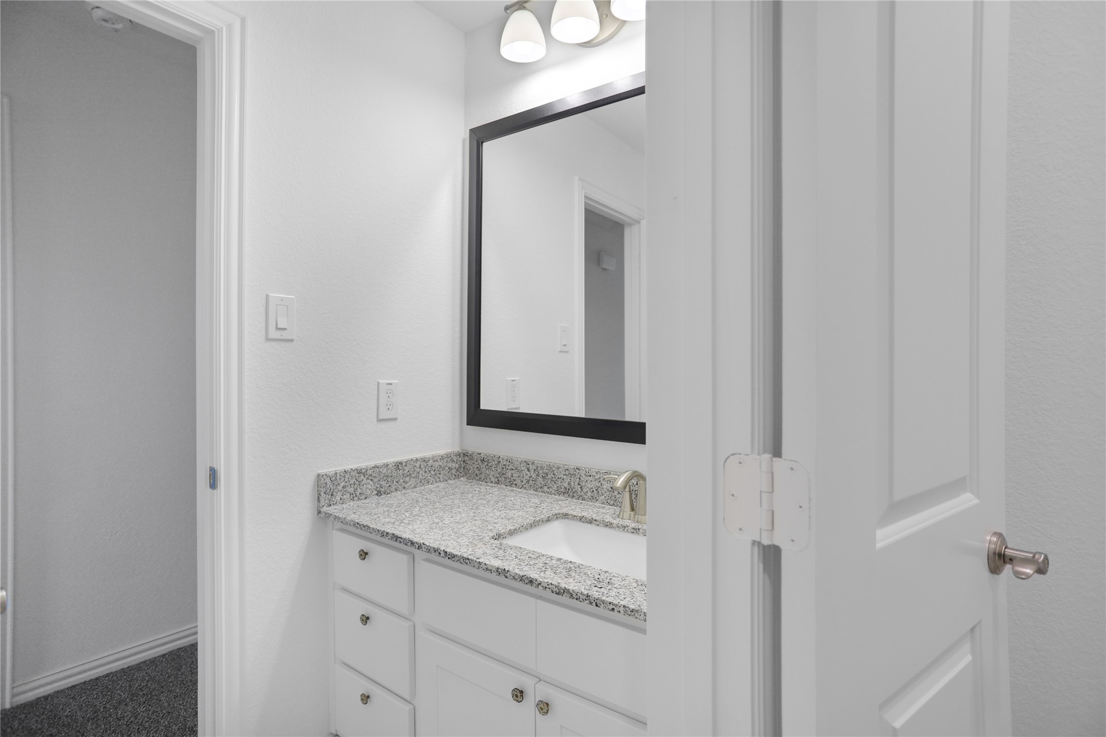 2718 Ripe Amber Cup Court Richmond, TX 77406 - Photo 28 of 43 a bathroom with a granite countertop sink and a mirror