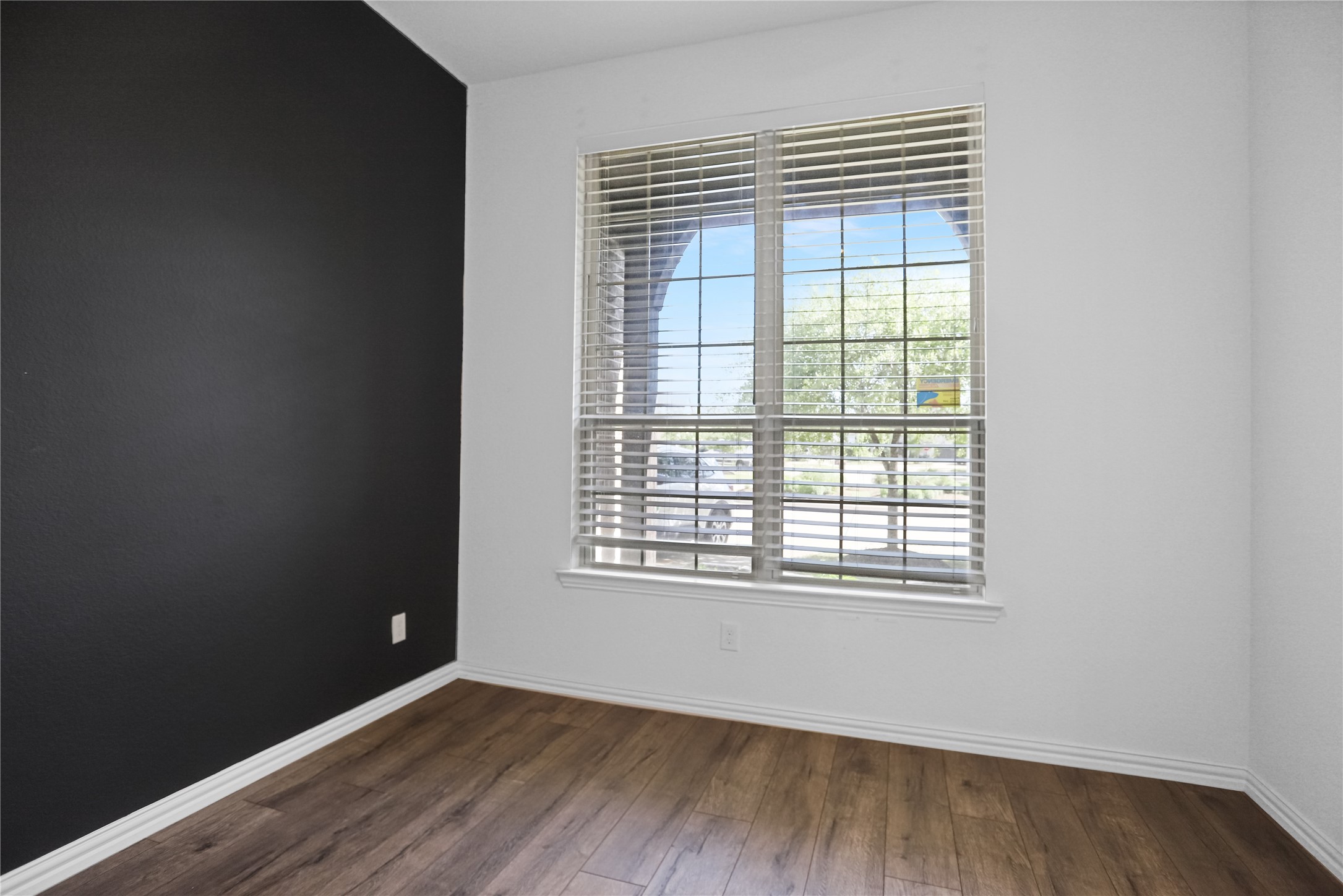 2718 Ripe Amber Cup Court Richmond, TX 77406 - Photo 32 of 43 an empty room with wooden floor and windows