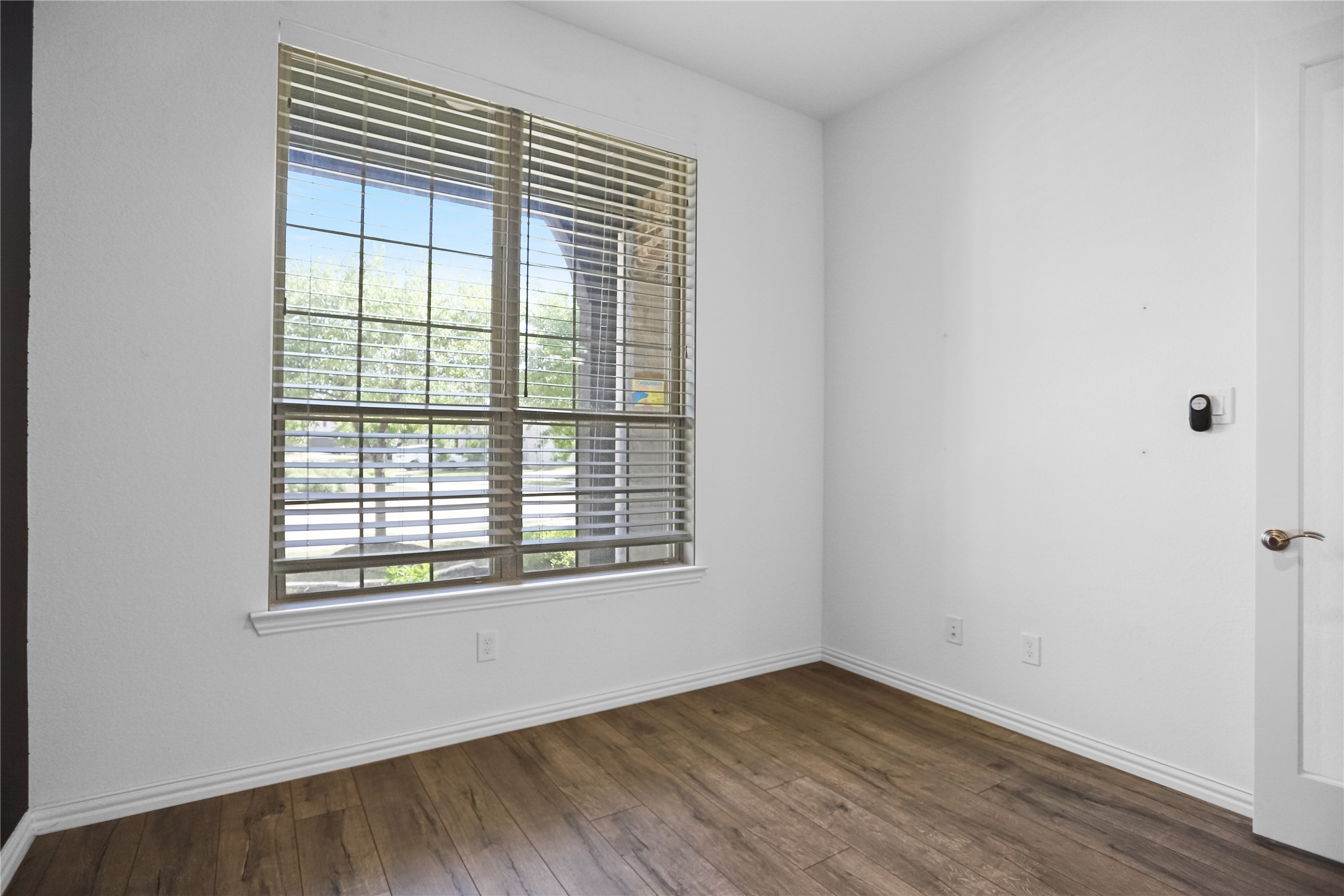 2718 Ripe Amber Cup Court Richmond, TX 77406 - Photo 33 of 43 an empty room with wooden floor and windows
