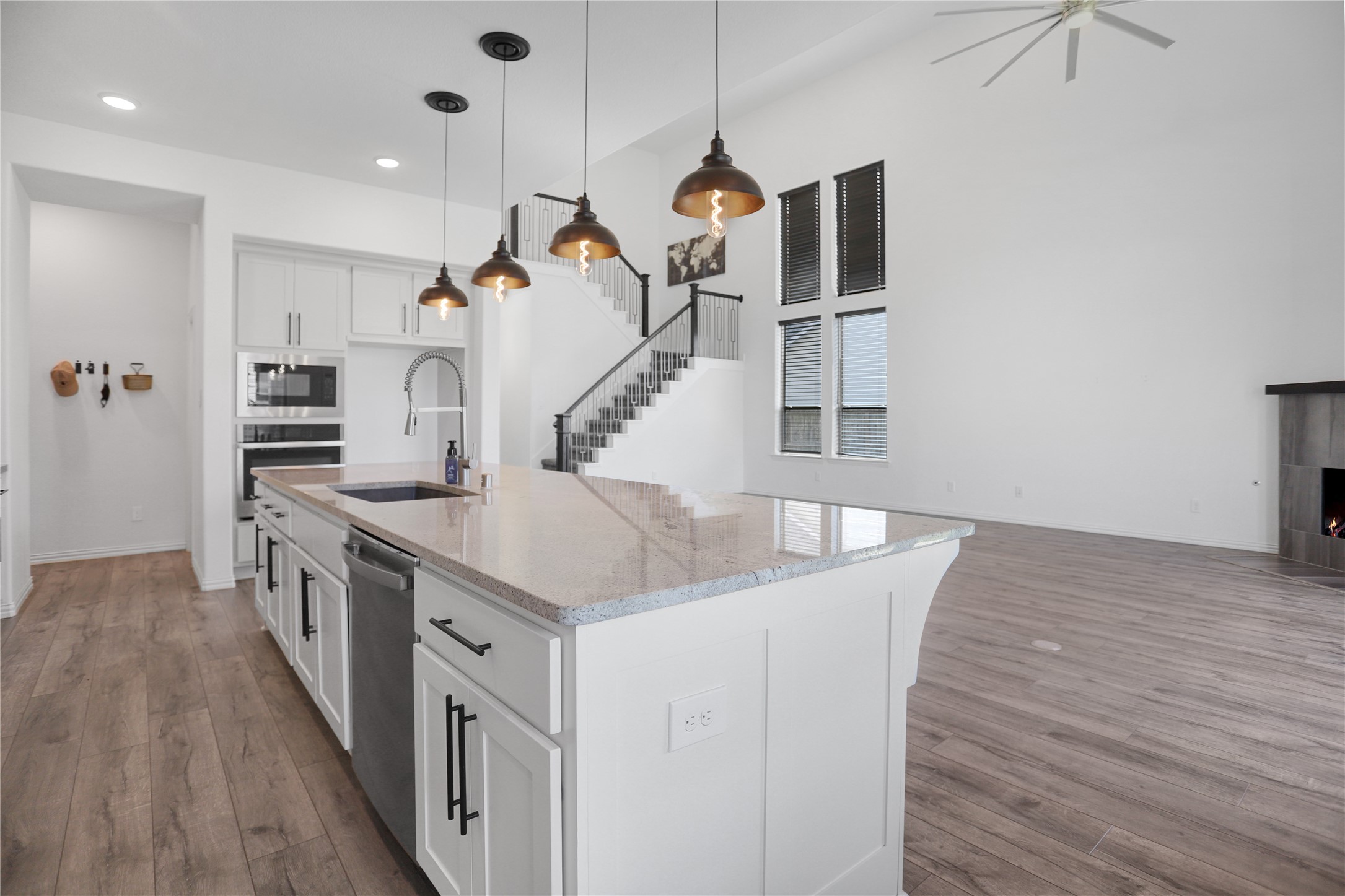 2718 Ripe Amber Cup Court Richmond, TX 77406 - Photo 7 of 43 a kitchen with stainless steel appliances granite countertop a kitchen island a stove and a wooden floors