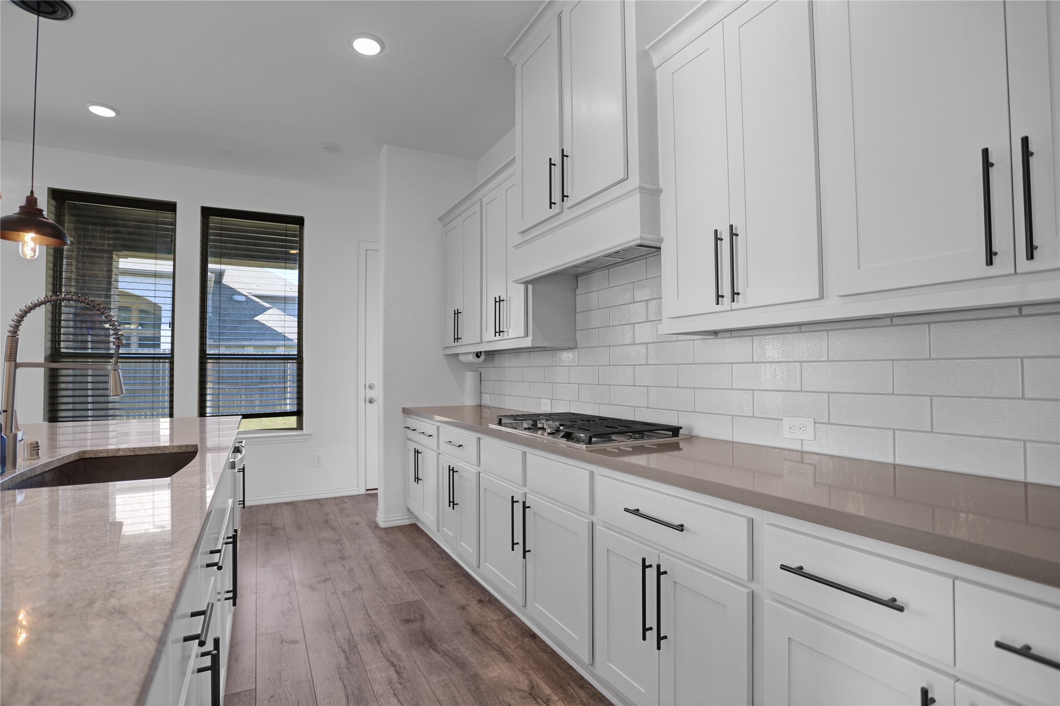 2718 Ripe Amber Cup Court Richmond, TX 77406 - Photo 10 of 43 a kitchen with stainless steel appliances granite countertop a stove a sink and white cabinets