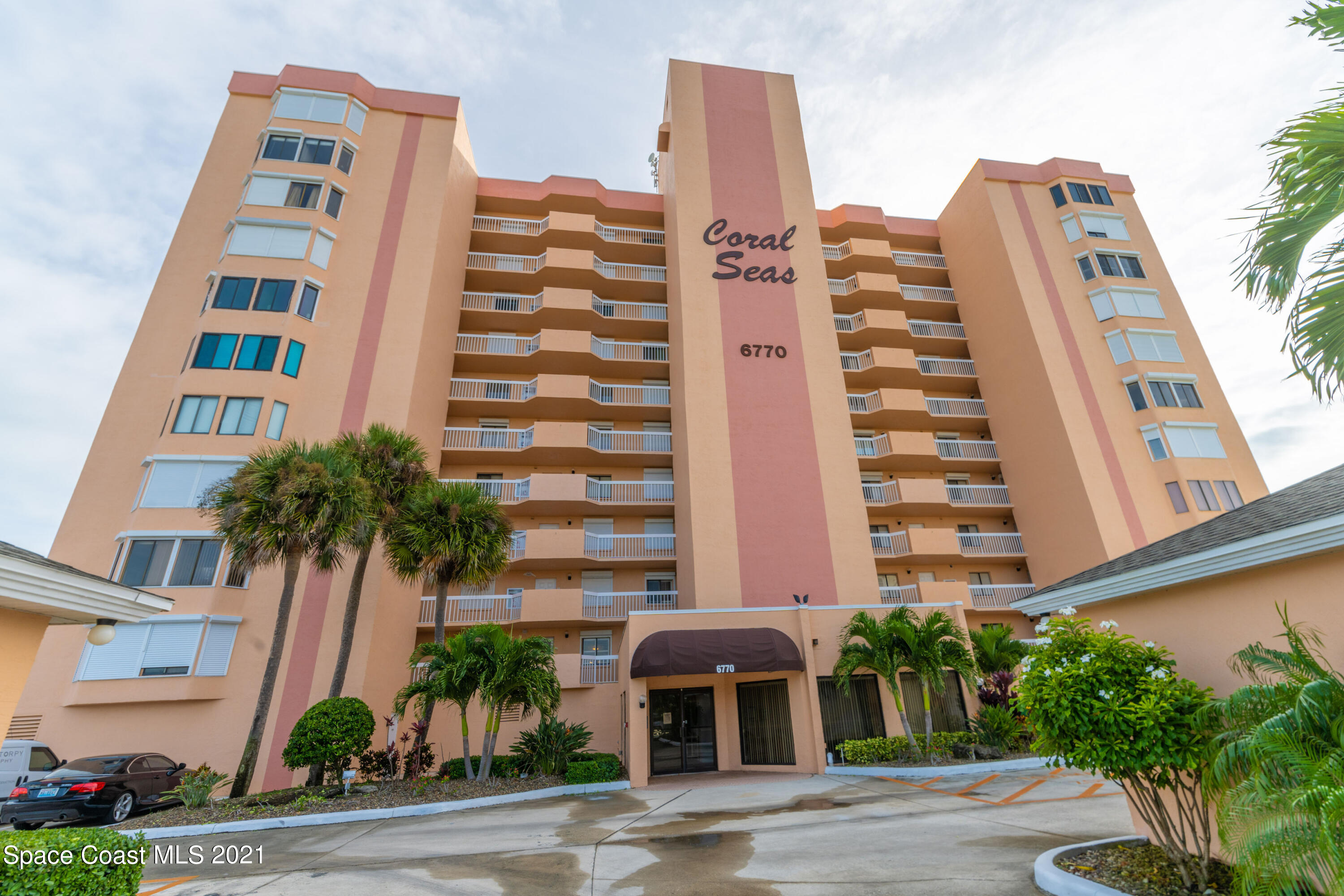 6770 Ridgewood Avenue, Unit 1002 Cocoa Beach, FL 32931 - Photo 2 of 16 a front view of multi story residential apartment building