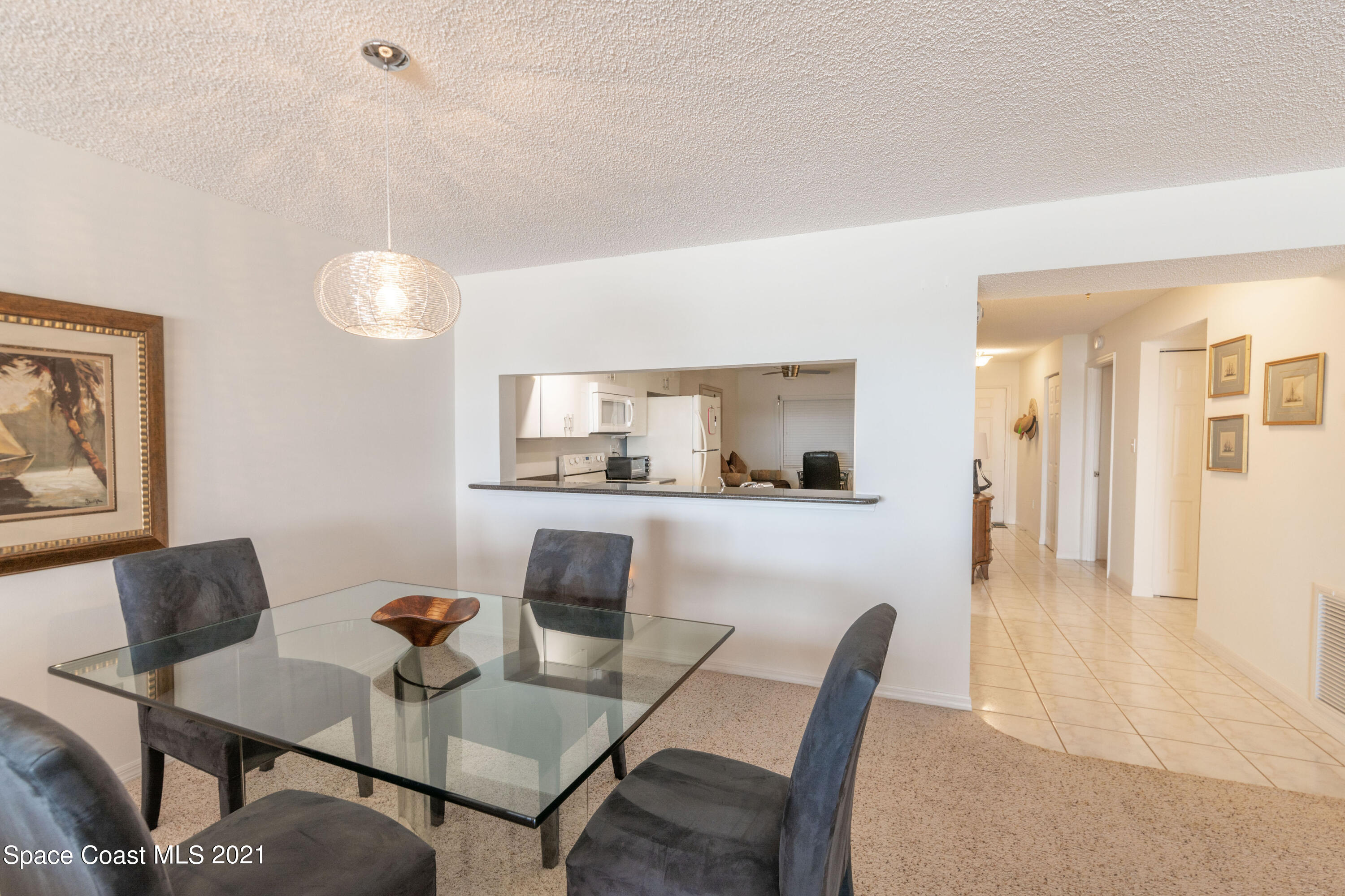 6770 Ridgewood Avenue, Unit 1002 Cocoa Beach, FL 32931 - Photo 11 of 16 a view of a dining room with furniture and wooden floor
