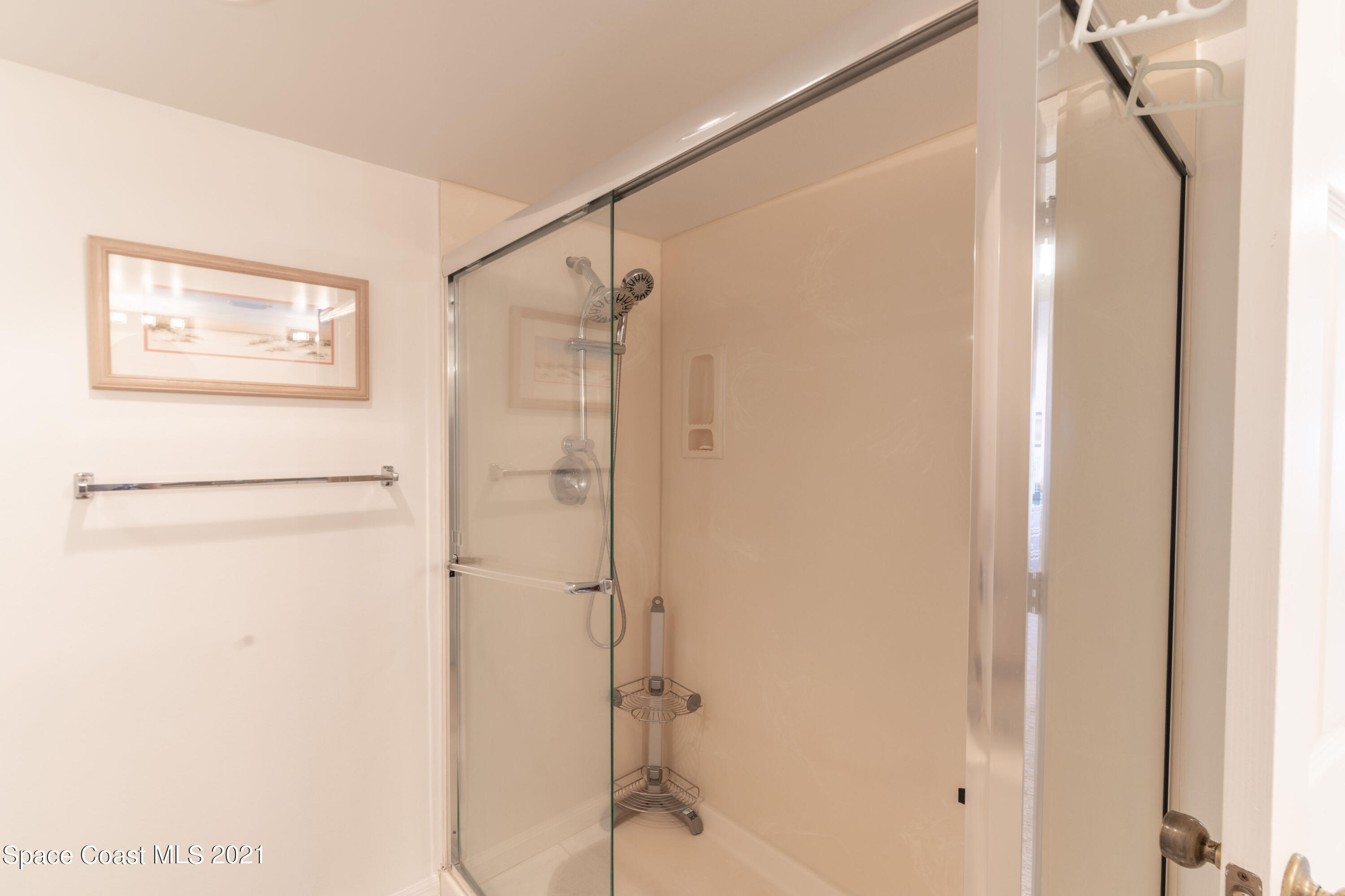 6770 Ridgewood Avenue, Unit 1002 Cocoa Beach, FL 32931 - Photo 14 of 16 a bathroom with a shower and a glass door