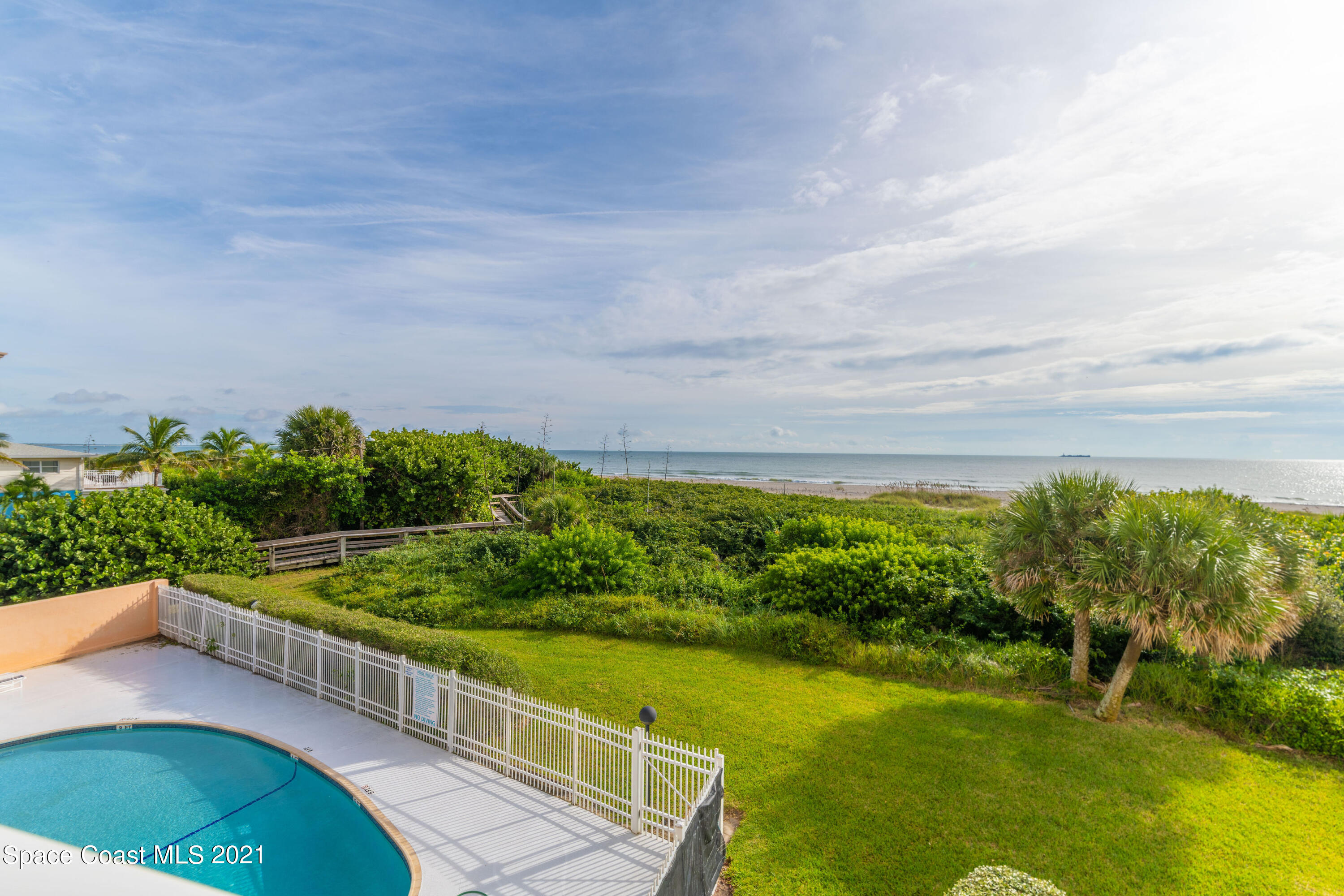 6770 Ridgewood Avenue, Unit 1002 Cocoa Beach, FL 32931 - Photo 3 of 16 a view of a balcony with lake