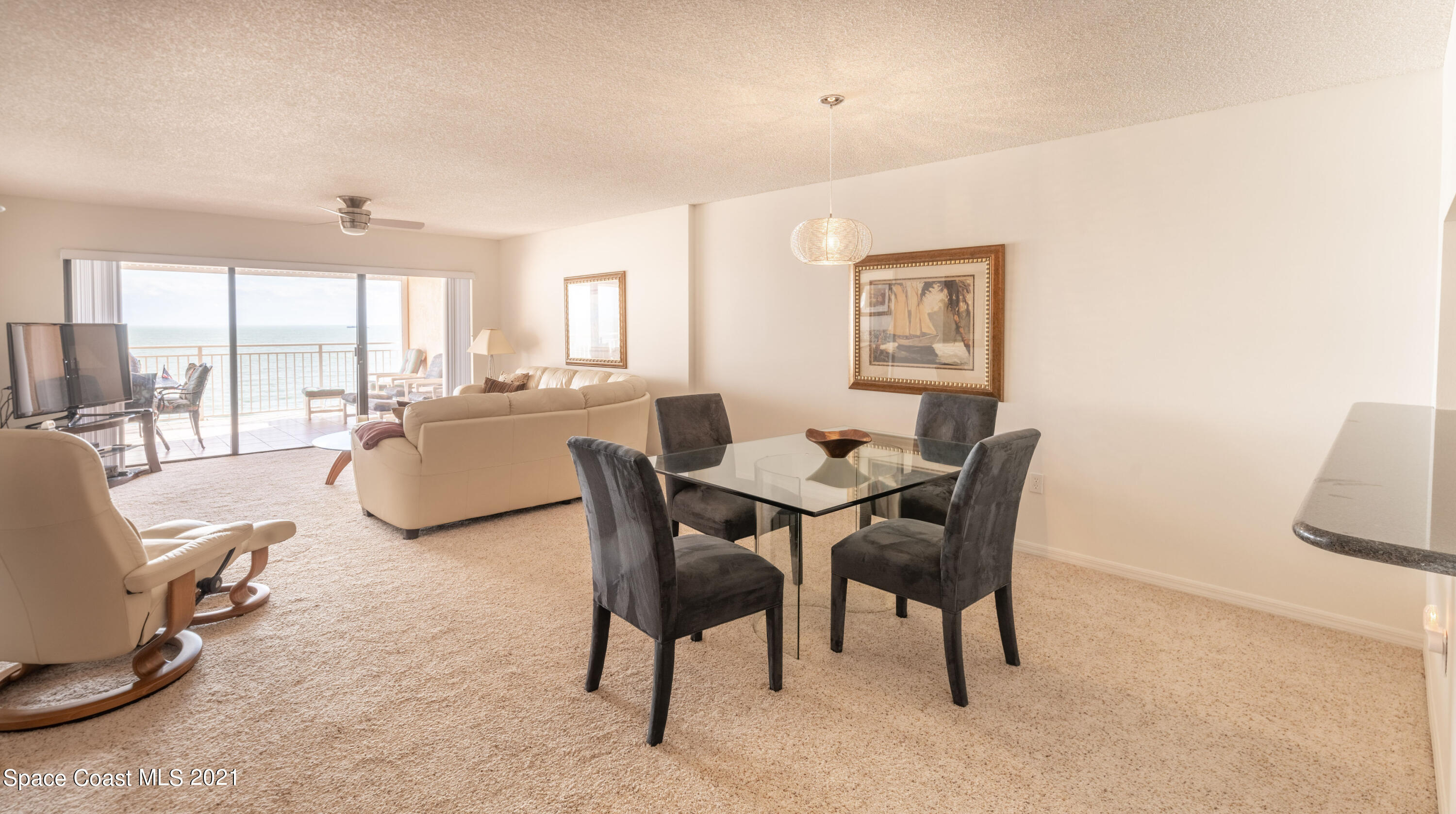 6770 Ridgewood Avenue, Unit 1002 Cocoa Beach, FL 32931 - Photo 8 of 16 a view of a dining room with furniture