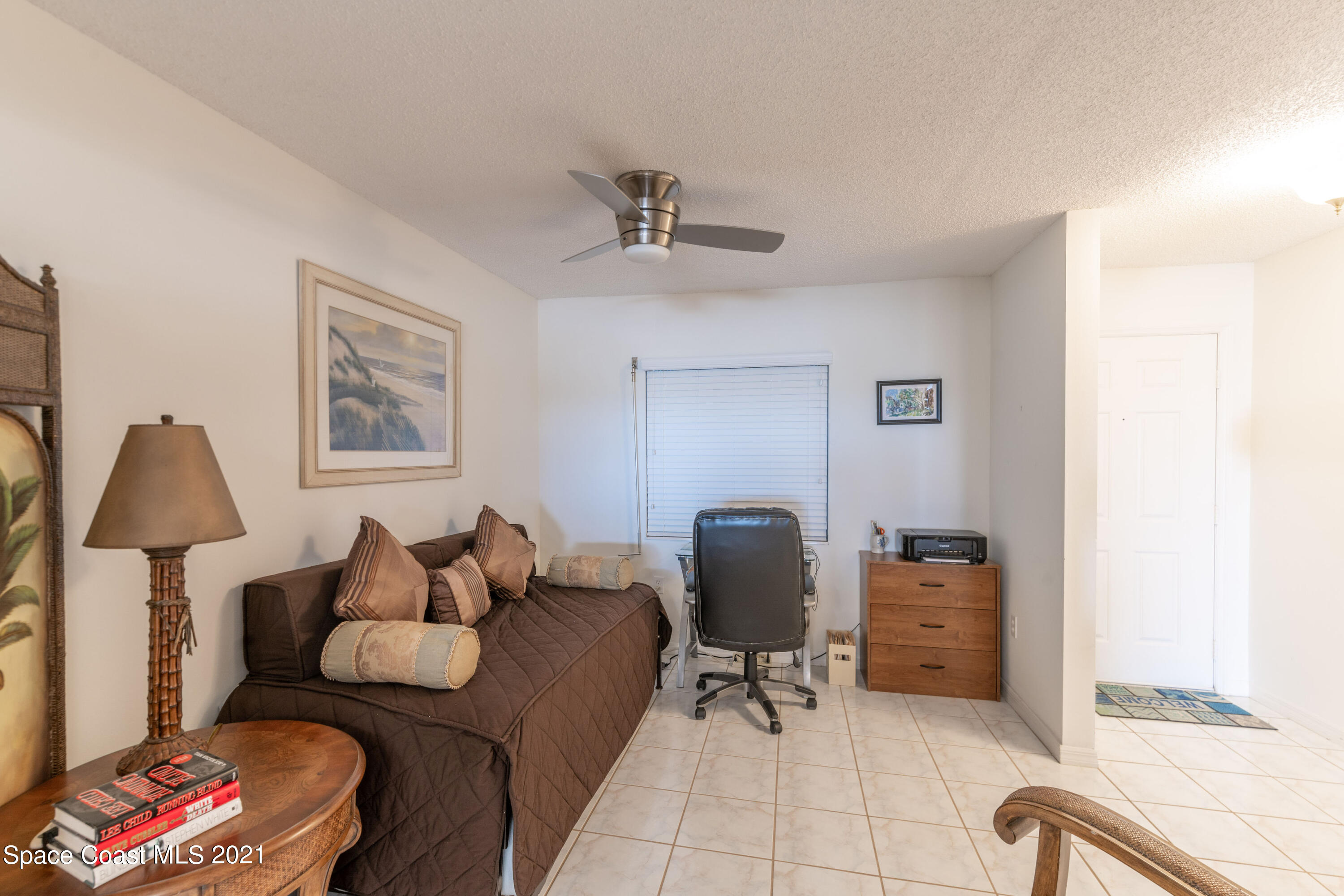 6770 Ridgewood Avenue, Unit 1002 Cocoa Beach, FL 32931 - Photo 10 of 16 a living room with furniture and a window