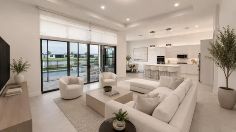 a large white kitchen with kitchen island a sink stainless steel appliances and cabinets
