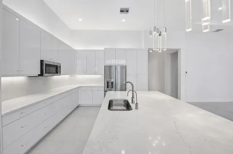 a bathroom with a double vanity sink mirror and shower