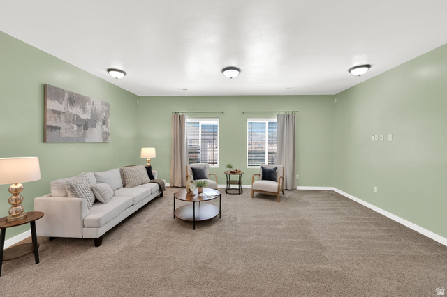 8215 Clear Rock Road, Unit 12 Eagle Mountain, UT 84005 - Photo 12 of 38 Spacious room featuring broadloom carpeting, light green wall finishes, and white baseboards