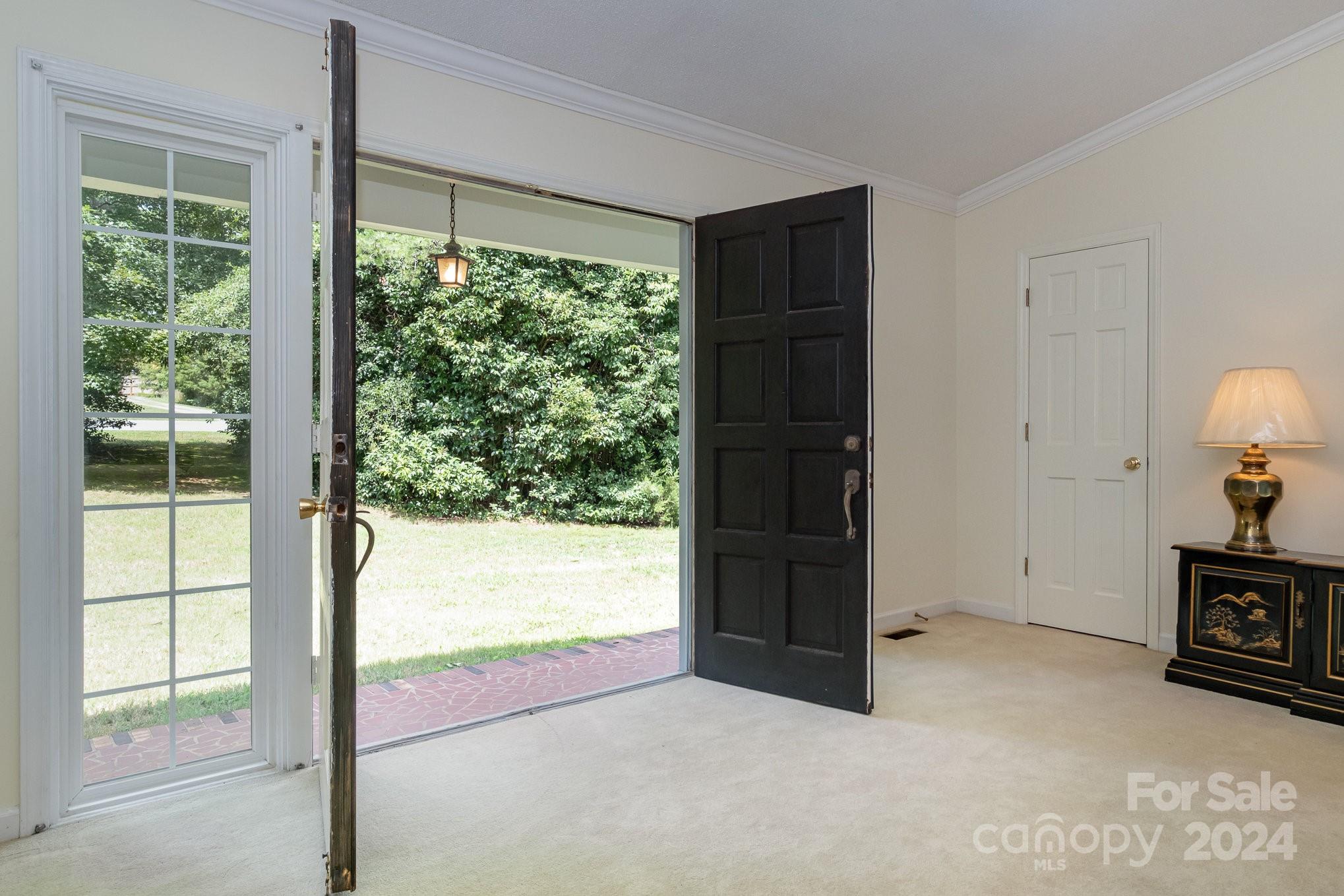 8208 Fairfield Forest Road Denver, NC 28037 - Photo 8 of 31 an empty room with window and wooden floor