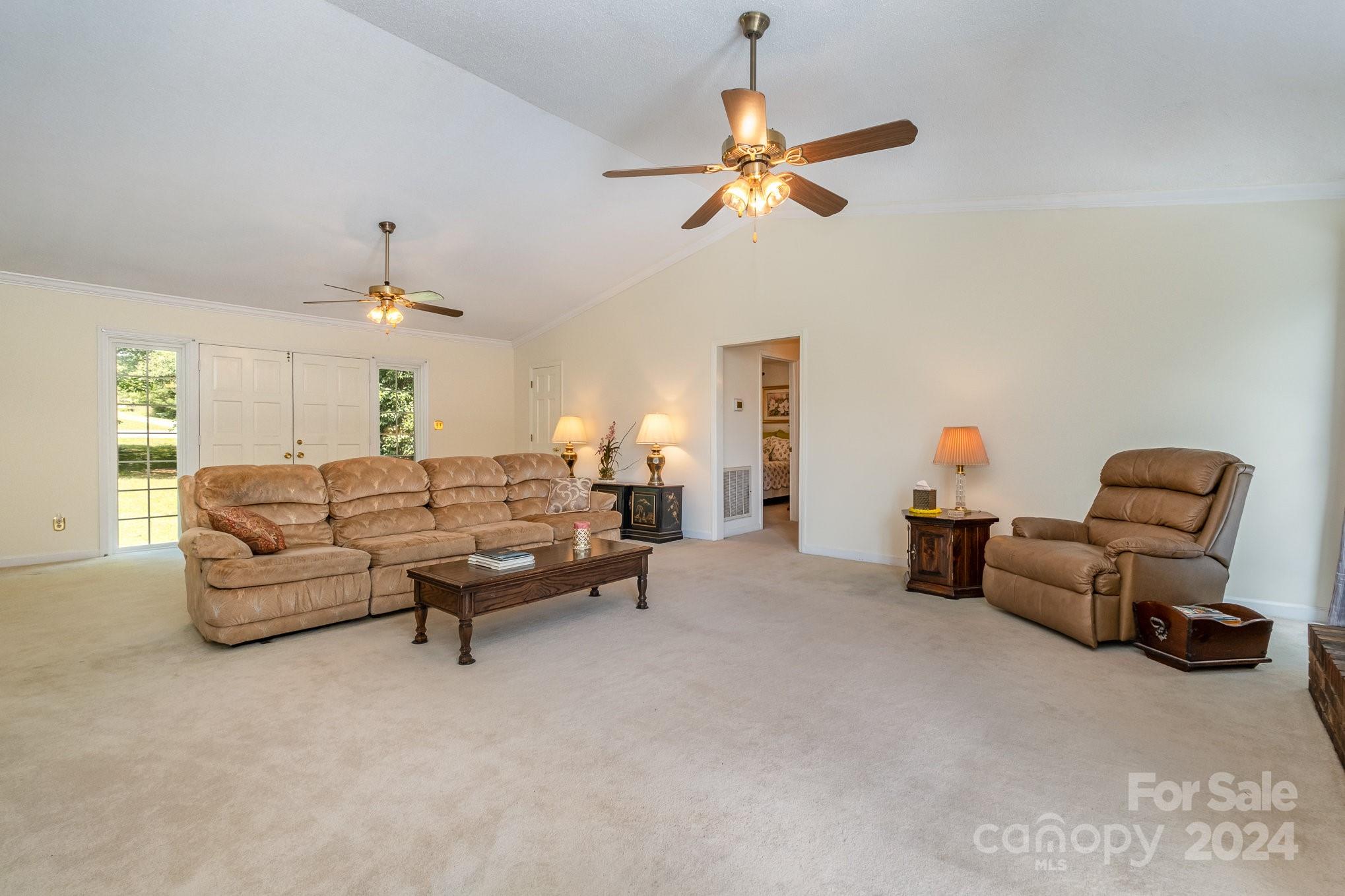8208 Fairfield Forest Road Denver, NC 28037 - Photo 10 of 31 a living room with furniture and a chandelier