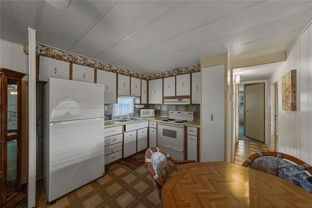 a kitchen with a refrigerator and a sink