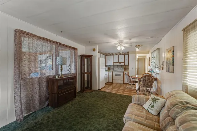 a living room with furniture and large window