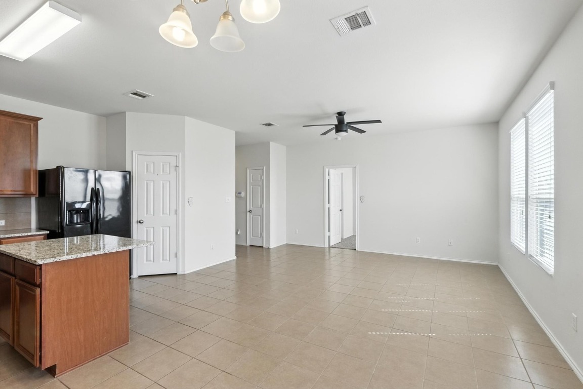 a view of a kitchen with a sink dishwasher and a fireplace
