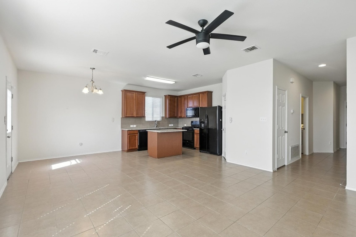 4617 Cleto Street Austin, TX 78725 - Photo 11 of 26 a view of a kitchen with a sink and a refrigerator
