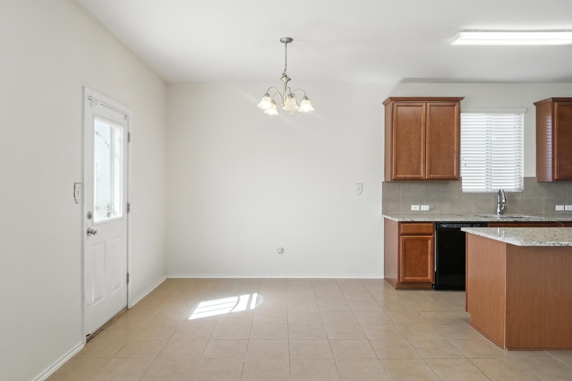 4617 Cleto Street Austin, TX 78725 - Photo 12 of 26 a view of a kitchen with granite countertop cabinets and a sink