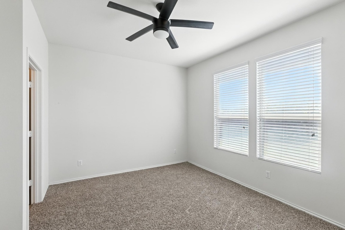 4617 Cleto Street Austin, TX 78725 - Photo 16 of 26 an empty room with a window and a fan