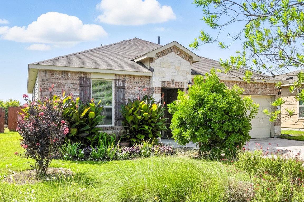 4617 Cleto Street Austin, TX 78725 - Photo 6 of 26 a front view of a house with a yard
