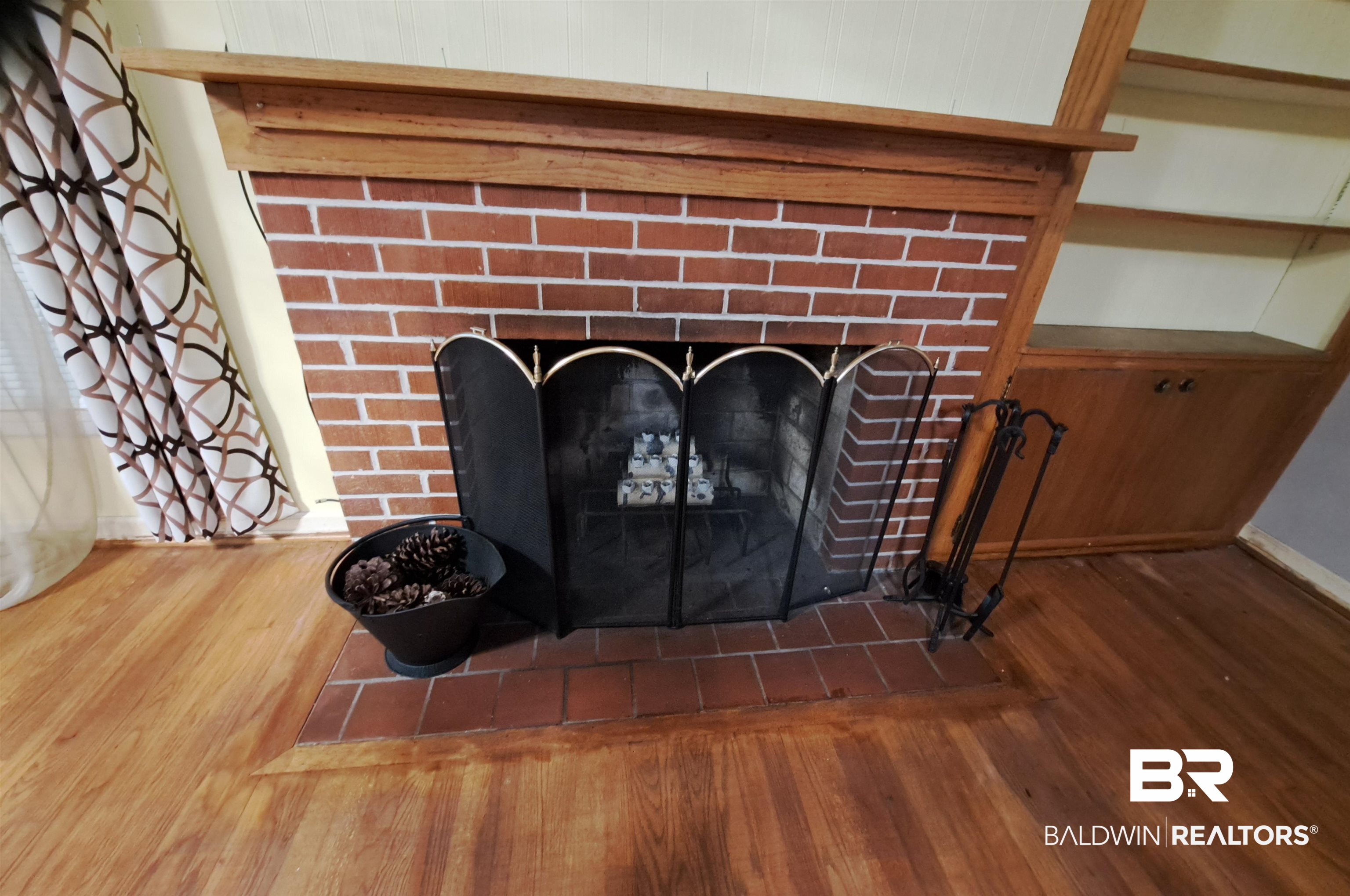 249 Newton Parkway Evergreen, AL 36401 - Photo 4 of 28 Detailed view of wood finished floors and a fireplace
