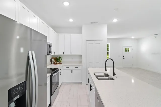 a kitchen with refrigerator and microwave