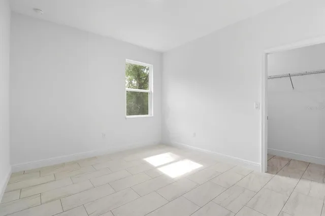 a view of a big room with closet and windows