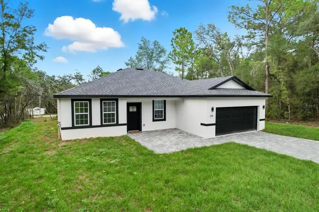 a front view of a house with a garden