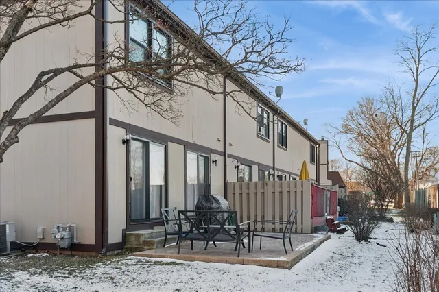 a backyard of a house with table and chairs
