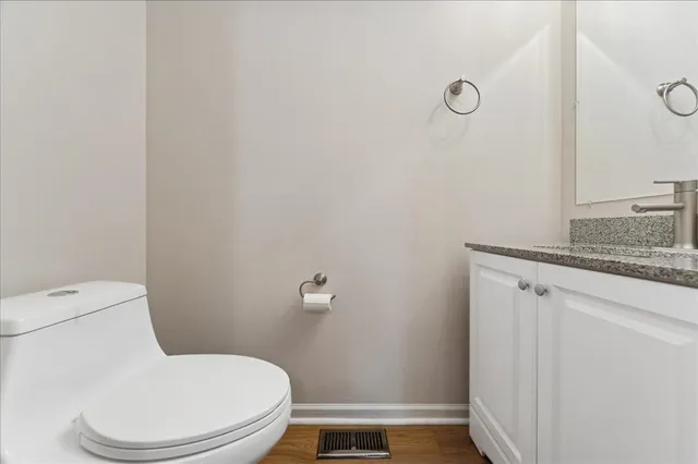 a white toilet sitting next to a bathroom sink