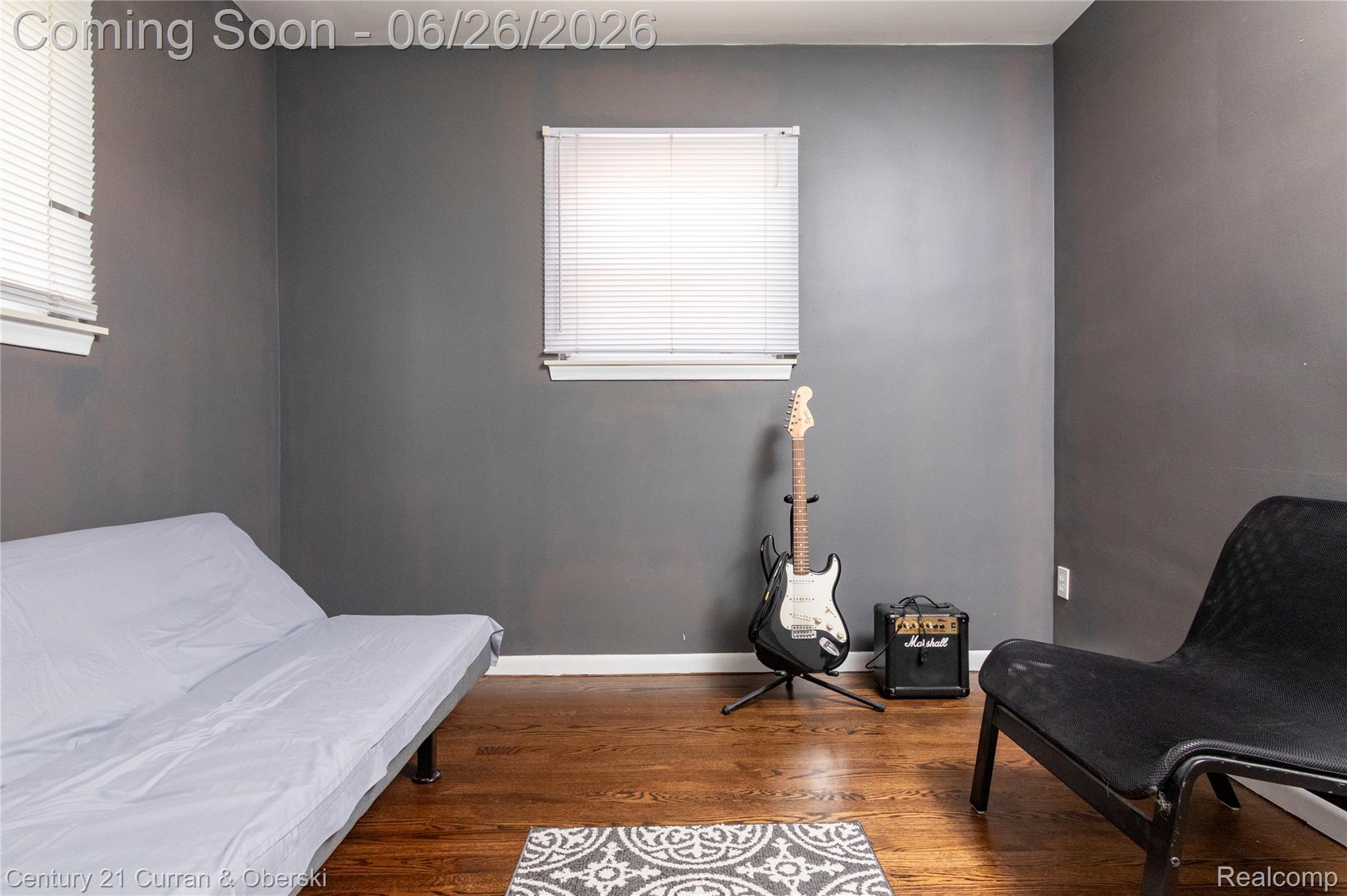 3220 Alice Street Dearborn, MI 48124 - Photo 15 of 39 Interior room with dark gray walls, two windows with white blinds, and rich wood-finish flooring