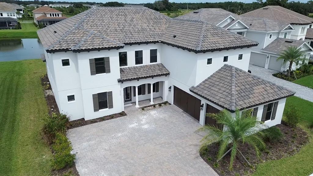 a aerial view of a house with roof deck front of house