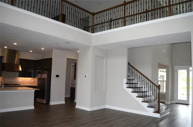 a view of kitchen with kitchen island and stainless steel appliances