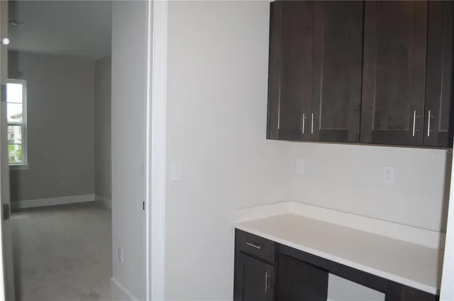 a view of a kitchen with wooden floor and a sink