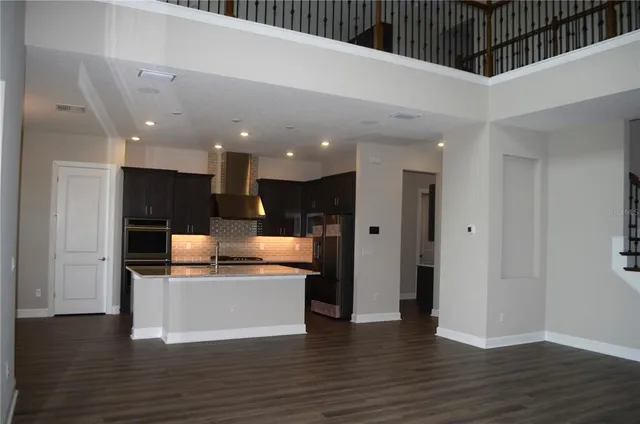 a kitchen with kitchen island granite countertop a stove and a refrigerator