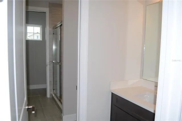 a bathroom with a sink and shower