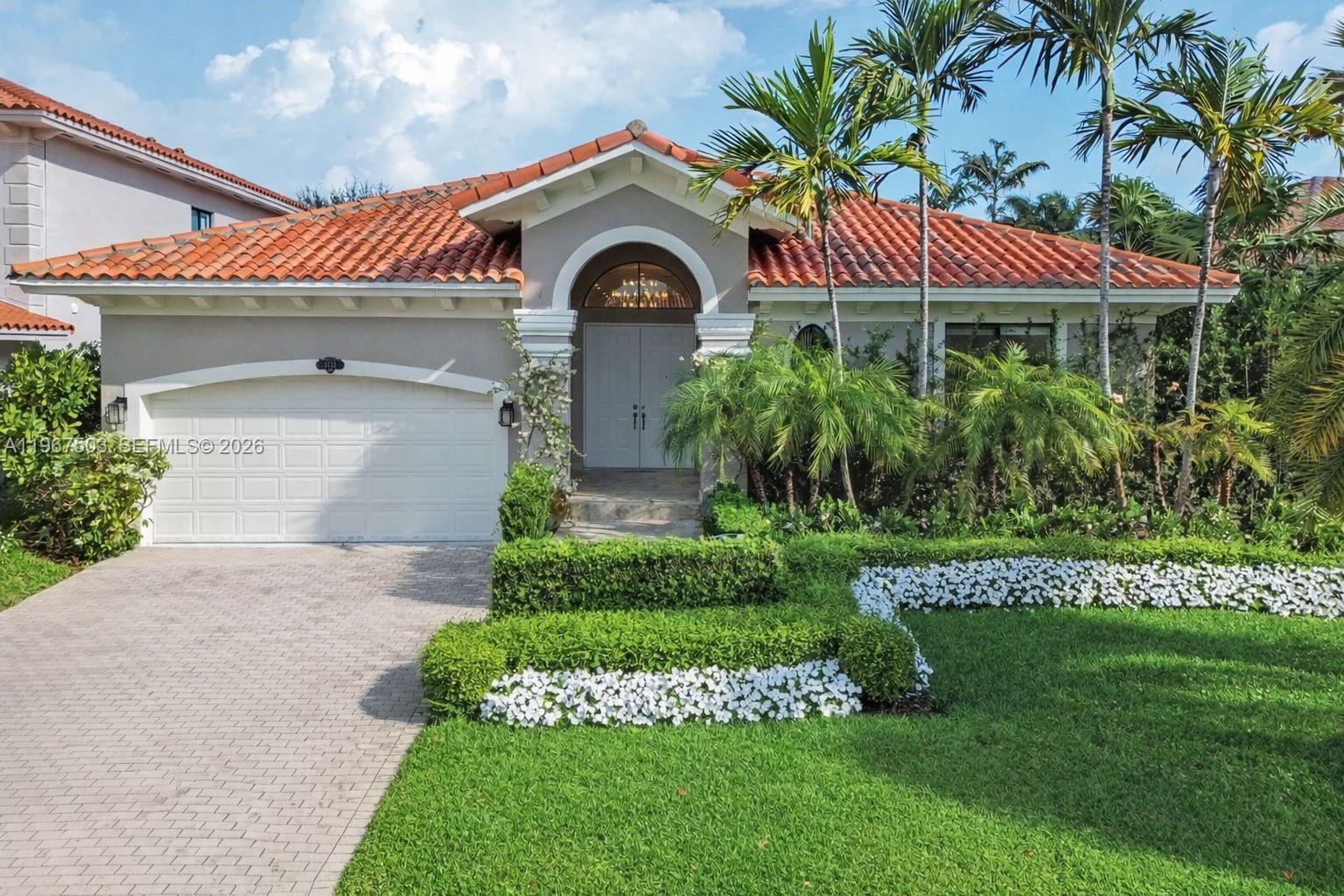 7733 Southwest 193rd Street Cutler Bay, FL 33157 - Photo 1 of 36 a front view of a house with a garden