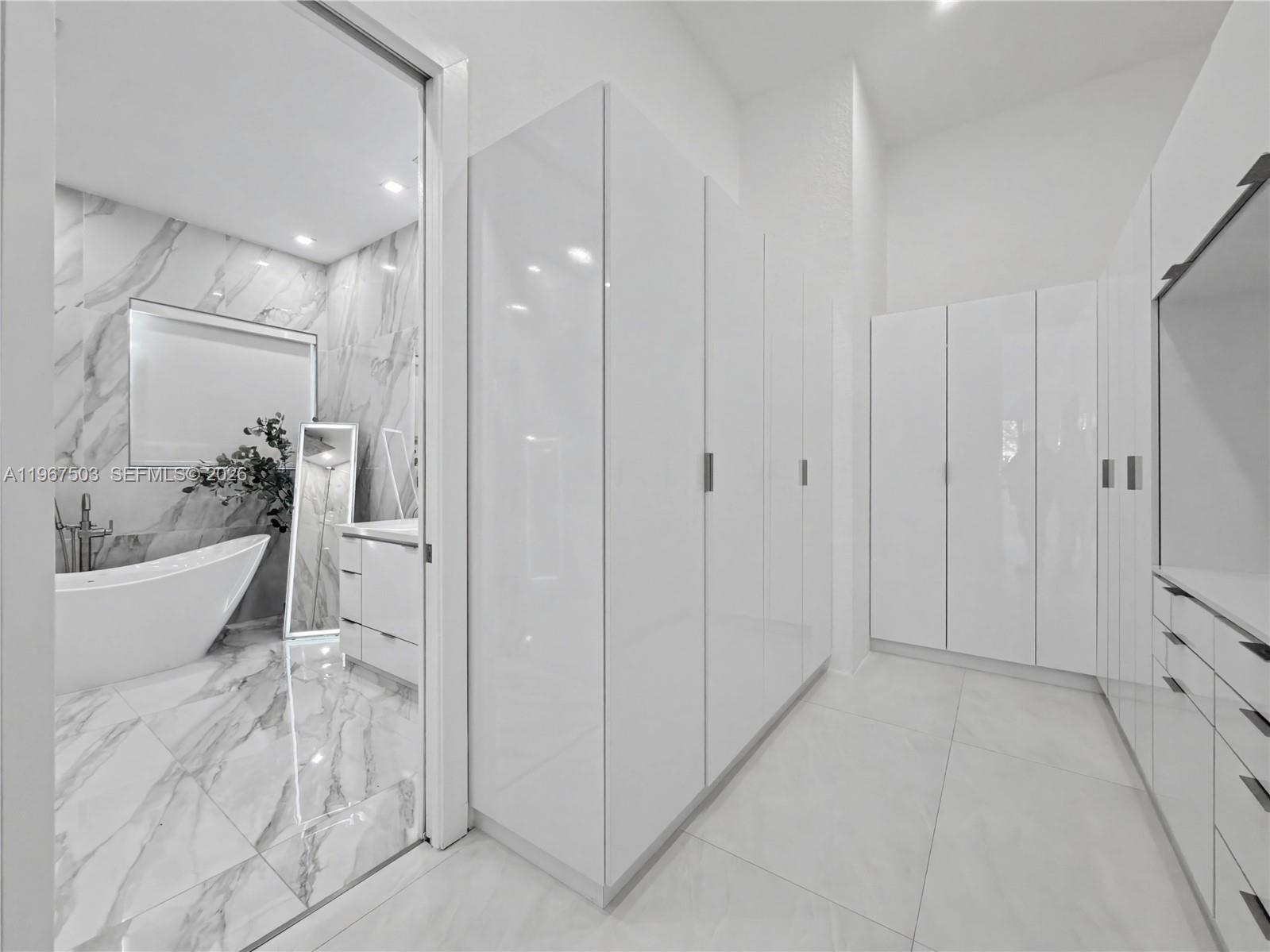 7733 Southwest 193rd Street Cutler Bay, FL 33157 - Photo 13 of 36 a bathroom with a bathtub and a shower